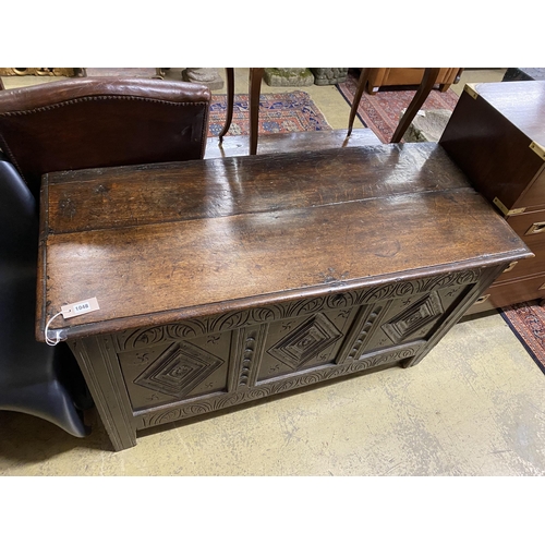 2048 - An 18th century carved panelled oak coffer, length 130cm, depth 54cm, height 72cm