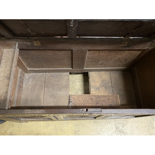 2048 - An 18th century carved panelled oak coffer, length 130cm, depth 54cm, height 72cm