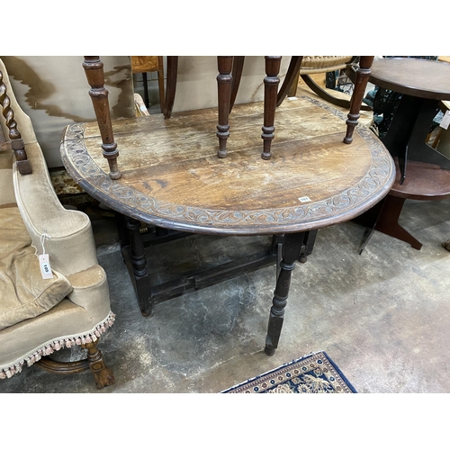 30 - An early 20th century carved oak gateleg table, width 120cm, depth 44cm, height 74cm