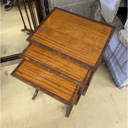 1024 - A nest of three rectangular rosewood banded satinwood tea tables, width 49cm, depth 38cm, height 60c... 