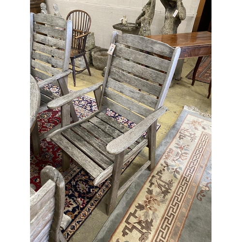 1073 - Lazy Dayz, New Zealand, a circular teak garden table, diameter 180cm, height 72cm and eight elbow ch... 