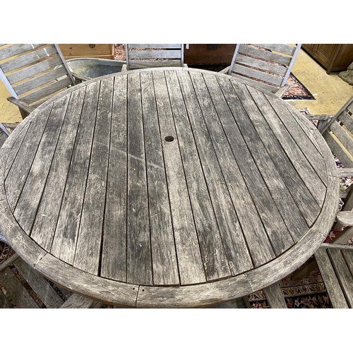 1073 - Lazy Dayz, New Zealand, a circular teak garden table, diameter 180cm, height 72cm and eight elbow ch... 