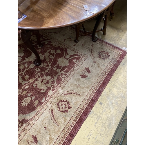 1118 - A Zeigler style burgundy ground carpet, 306 x 245cm