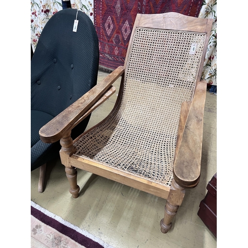 107 - A caned hardwood plantation chair, cane seat damaged, width 66cm, depth 92cm, height 94cm