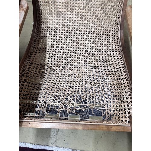 107 - A caned hardwood plantation chair, cane seat damaged, width 66cm, depth 92cm, height 94cm