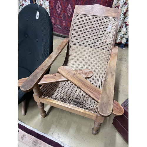 107 - A caned hardwood plantation chair, cane seat damaged, width 66cm, depth 92cm, height 94cm