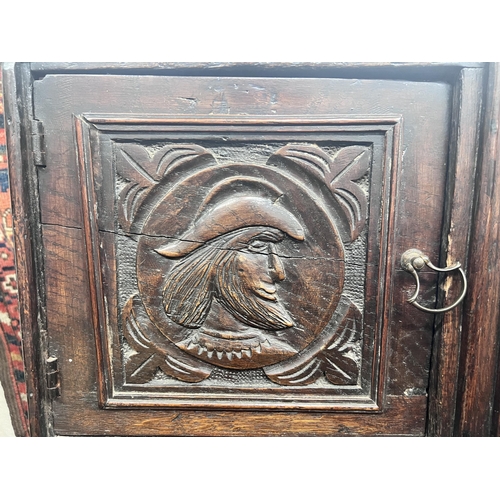 11 - An 18th century style Flemish carved oak side cabinet, width 80cm, depth 62cm, height 165cm