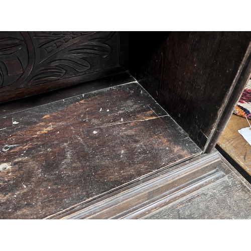 11 - An 18th century style Flemish carved oak side cabinet, width 80cm, depth 62cm, height 165cm