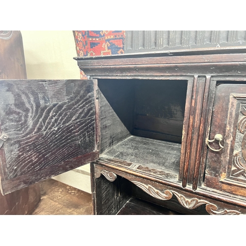 11 - An 18th century style Flemish carved oak side cabinet, width 80cm, depth 62cm, height 165cm