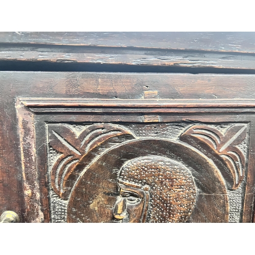 11 - An 18th century style Flemish carved oak side cabinet, width 80cm, depth 62cm, height 165cm