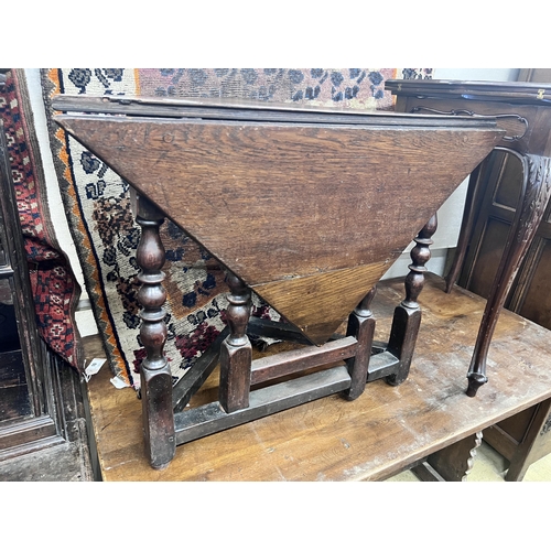 12 - An 18th century oak triangular drop leaf table, width 86cm, depth 45cm, height 69cm