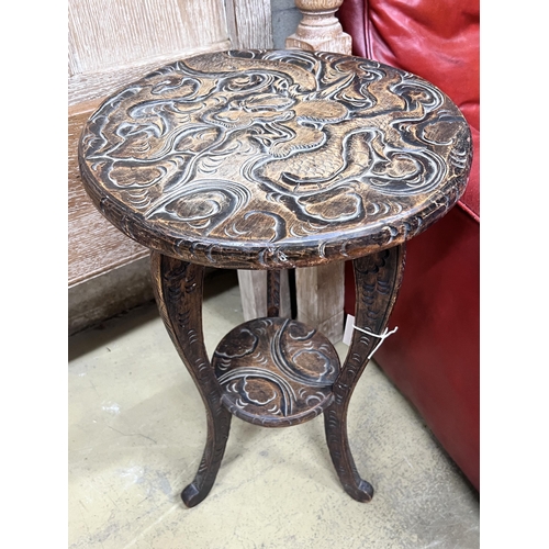 124 - A Japanese circular carved wood two tier occasional table, diameter 40cm, height 70cm