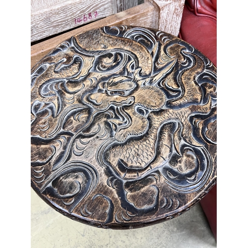 124 - A Japanese circular carved wood two tier occasional table, diameter 40cm, height 70cm