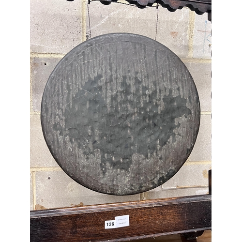 126 - An early 20th century oak dinner gong with striker, width 68cm, height 99cm