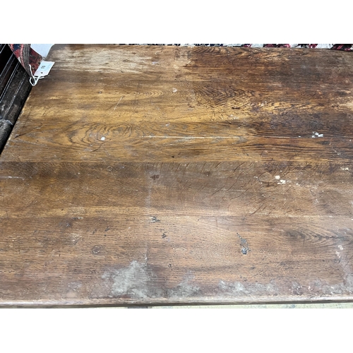 13 - A 1920's rectangular oak dining table, length 145cm, depth 74cm, height 76cm