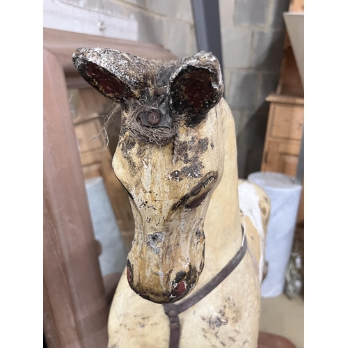 132 - An early 20th century rocking horse on pine safety frame, length 152cm, height 98cm