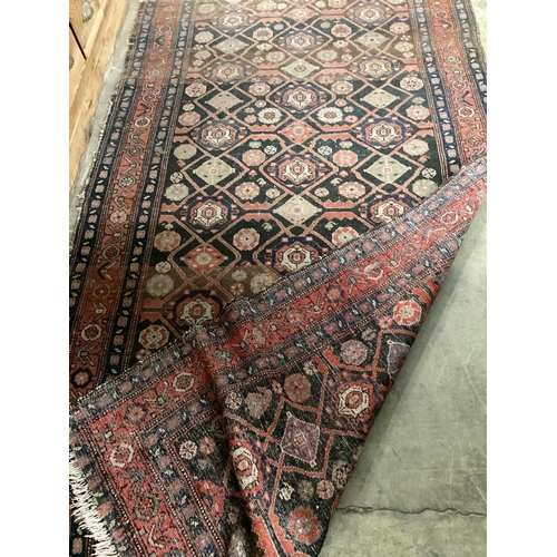 143 - An antique Hamadan blue ground rug, 270cm x 120cm