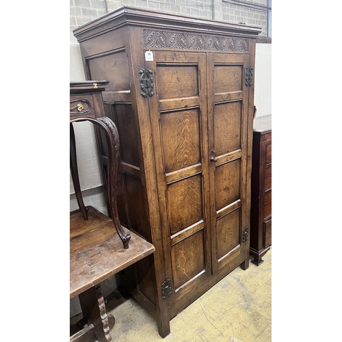 16 - An 18th century style panelled oak hanging cupboard, width 96cm, depth 53cm, height 178cm