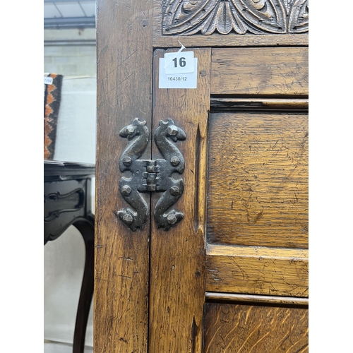 16 - An 18th century style panelled oak hanging cupboard, width 96cm, depth 53cm, height 178cm