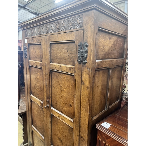 16 - An 18th century style panelled oak hanging cupboard, width 96cm, depth 53cm, height 178cm