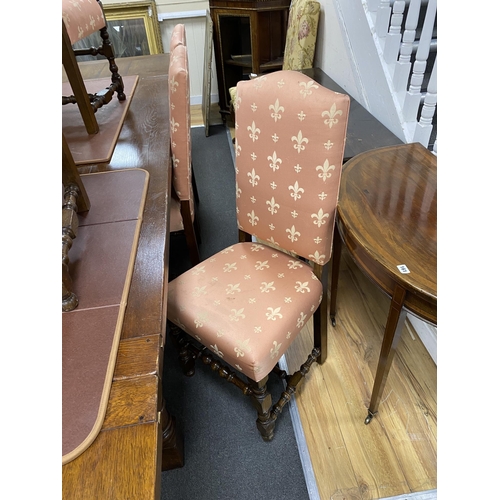 162 - A set of eight 18th century style oak dining chairs with fleur de lys upholstery, two with arms... 