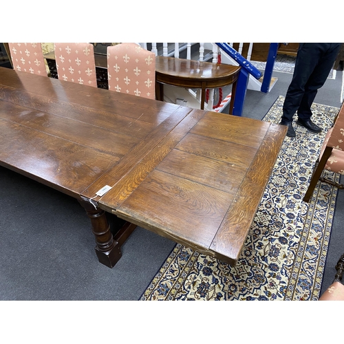 163 - An 18th century style rectangular oak extending refectory dining table, length 342cm extended with t... 