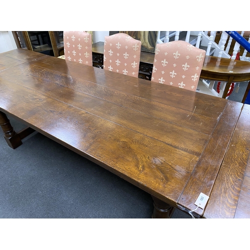 163 - An 18th century style rectangular oak extending refectory dining table, length 342cm extended with t... 