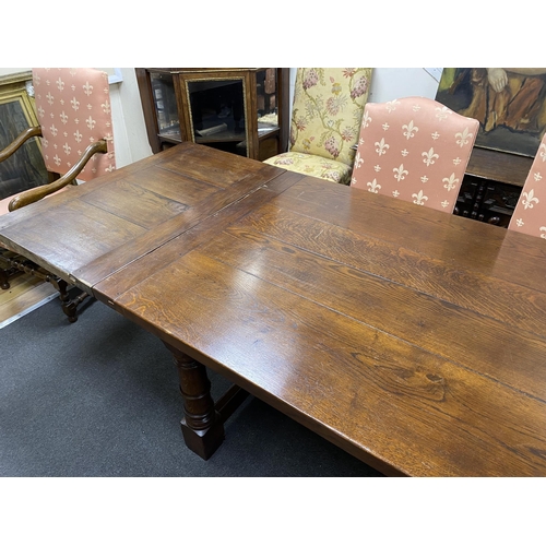 163 - An 18th century style rectangular oak extending refectory dining table, length 342cm extended with t... 