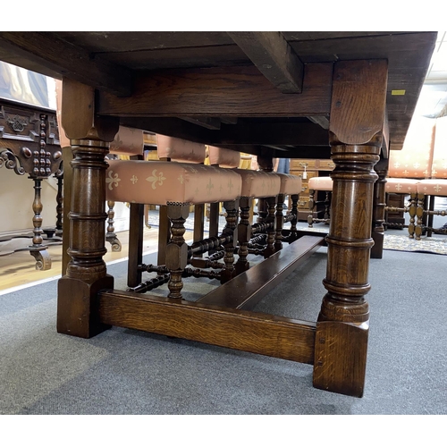 163 - An 18th century style rectangular oak extending refectory dining table, length 342cm extended with t... 