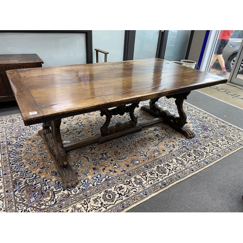 167 - A 17th century style Italian design walnut refectory dining table, with carved angel head underframe... 