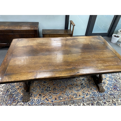 167 - A 17th century style Italian design walnut refectory dining table, with carved angel head underframe... 