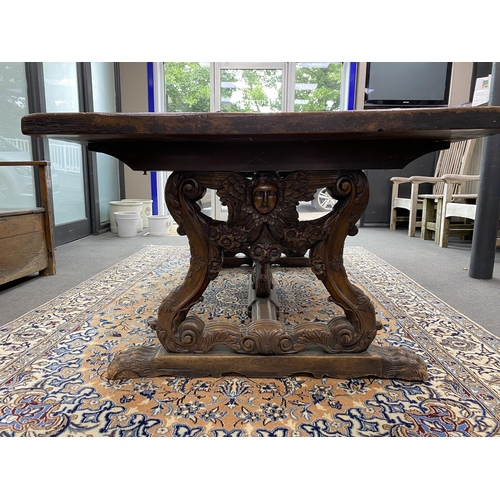 167 - A 17th century style Italian design walnut refectory dining table, with carved angel head underframe... 