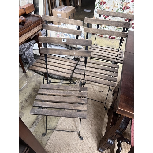 23 - A set of four wrought iron slatted wood folding garden chairs