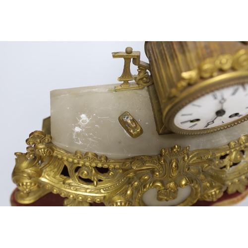 275 - A French gilt-metal and onyx mantel clock, on shaped base, a.f., 52cm high