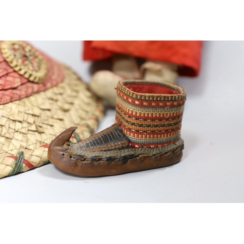 308 - A composition Burmese doll, 40cm, related hat and a shoe