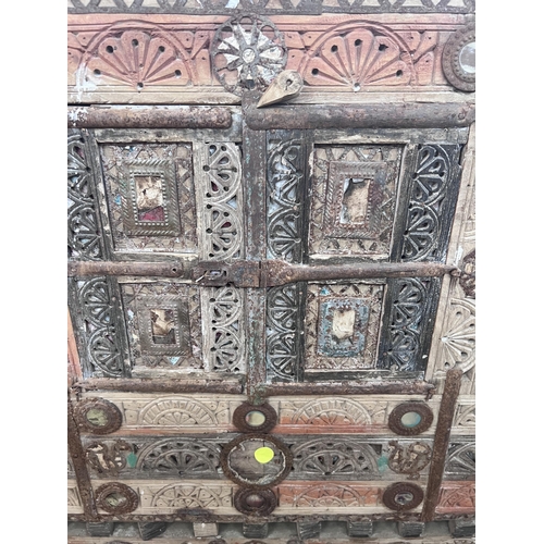 31 - An Indian painted carved hardwood cabinet, width 124cm, depth 43cm, height 125cm