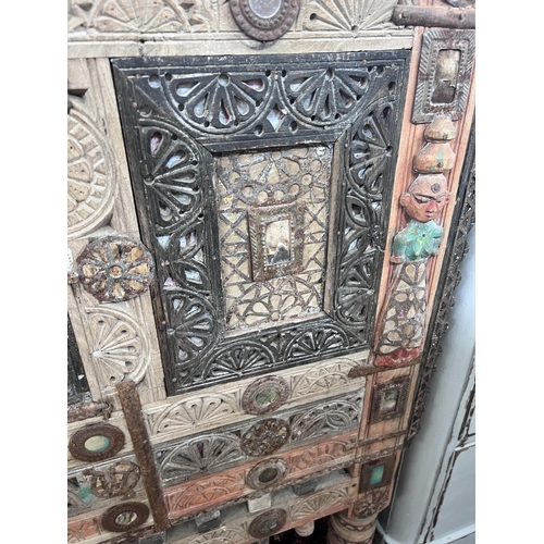 31 - An Indian painted carved hardwood cabinet, width 124cm, depth 43cm, height 125cm