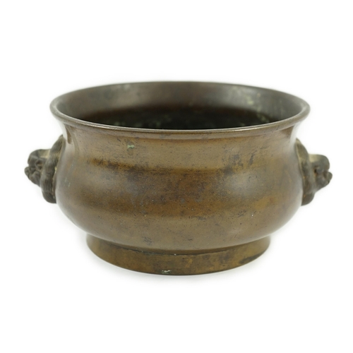 318 - A Chinese bronze censer, gui, 18th century, with olive-brown patina, cast with a pair of lion-mask h... 