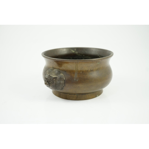 318 - A Chinese bronze censer, gui, 18th century, with olive-brown patina, cast with a pair of lion-mask h... 