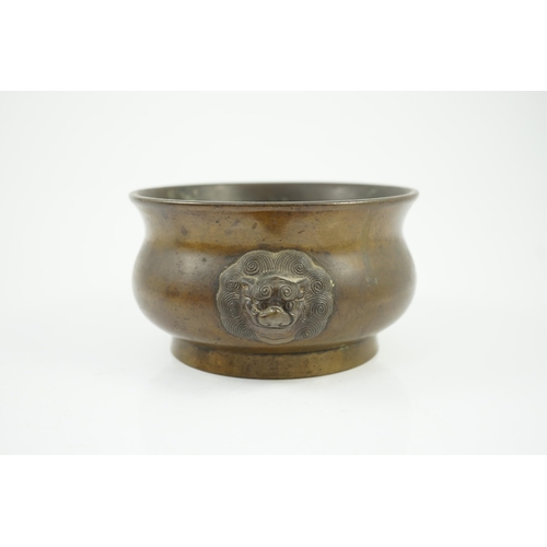 318 - A Chinese bronze censer, gui, 18th century, with olive-brown patina, cast with a pair of lion-mask h... 