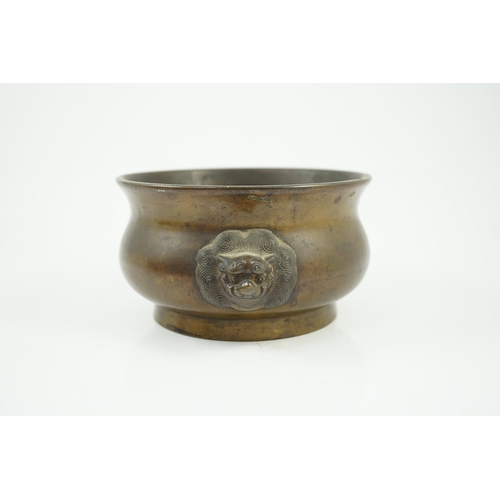 318 - A Chinese bronze censer, gui, 18th century, with olive-brown patina, cast with a pair of lion-mask h... 