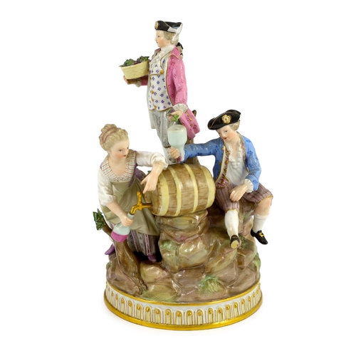 329 - A Meissen group of grape pickers with barrels of wine, 19th century, modelled on a rockwork and tree... 