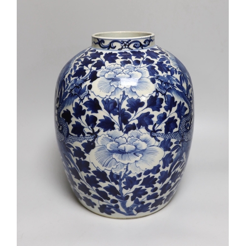 330 - A large Chinese blue and white jar painted with a dragon amongst leaves and flowers, 29cm high... 