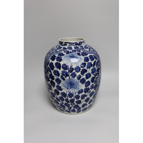 330 - A large Chinese blue and white jar painted with a dragon amongst leaves and flowers, 29cm high... 