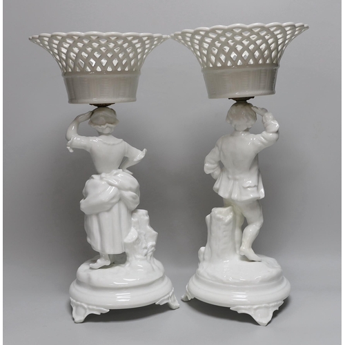 361 - A pair of Paris porcelain figural comports or centre pieces with lattice work baskets, each 38cm hig... 