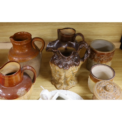 362 - A Victorian stoneware jug, the sides moulded with bacchanalians, together with other earthenware jug... 