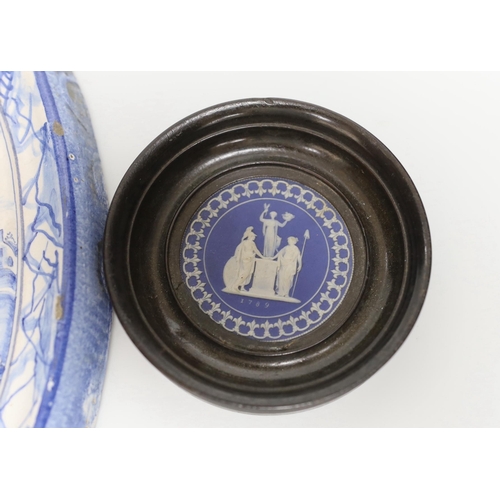 368 - A framed Wedgwood jasperware circular plaque dated 1789 and a delft blue and white example, the larg... 