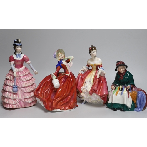 369 - Four Royal Doulton figurines including Autumn Breezes and an oversized Christian Dior advertising sc... 