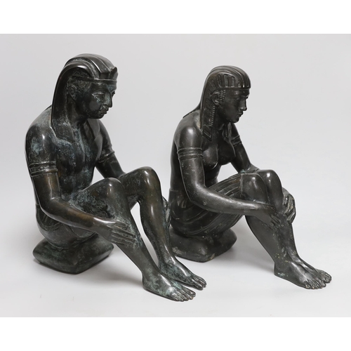 374 - A pair of cast bronze seated Egyptian figures wearing headdresses, the largest 30cm high