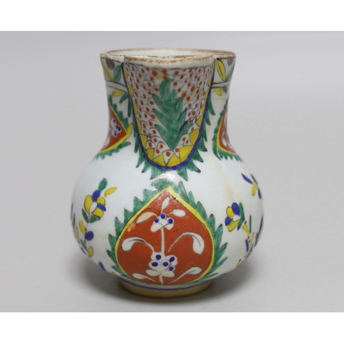 390 - Turkish Kutahya pottery jug hand painted with stylised flowers, 12.5cm high